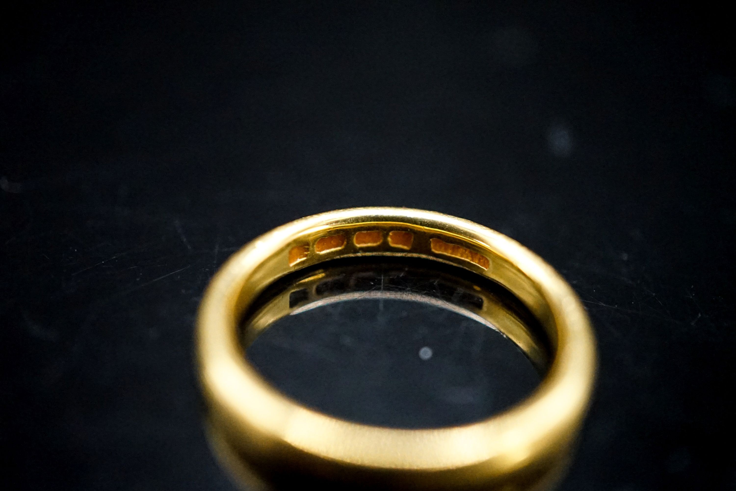 A 22ct gold wedding band, size L/M, 4.6 grams.